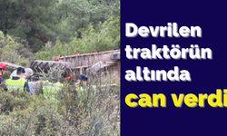 Devrilen traktörün altında can verdi