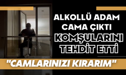 Alkollü adam cama çıktı, komşularını tehdit etti