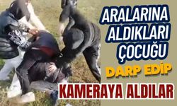 Aralarına aldıkları çocuğu darp edip kameraya aldılar