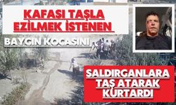 Kafası taşla ezilmek istenen baygın kocasını saldırganlara taş atarak kurtardı