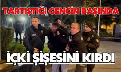 Tartıştığı gencin başında içki şişesini kırdı