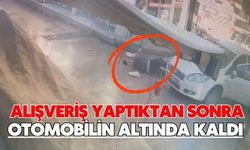 Alışveriş yaptıktan sonra otomobilin altında kaldı