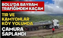 Bolu'da bayram trafiğinden kaçan tır ve kamyonlar köy yolunda çamura saplandı