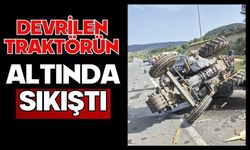 Devrilen traktörün altında sıkıştı