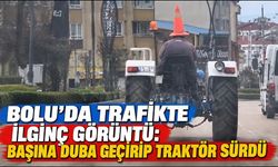 Bolu'da trafikte ilginç görüntü: Başına duba geçirip traktör sürdü