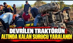 Devrilen traktörün altında kalan sürücü yaralandı