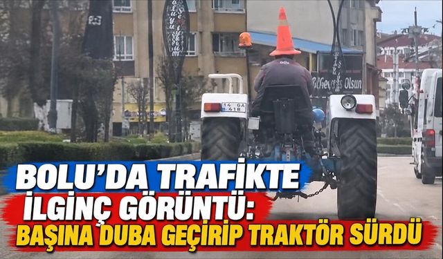 Bolu'da trafikte ilginç görüntü: Başına duba geçirip traktör sürdü