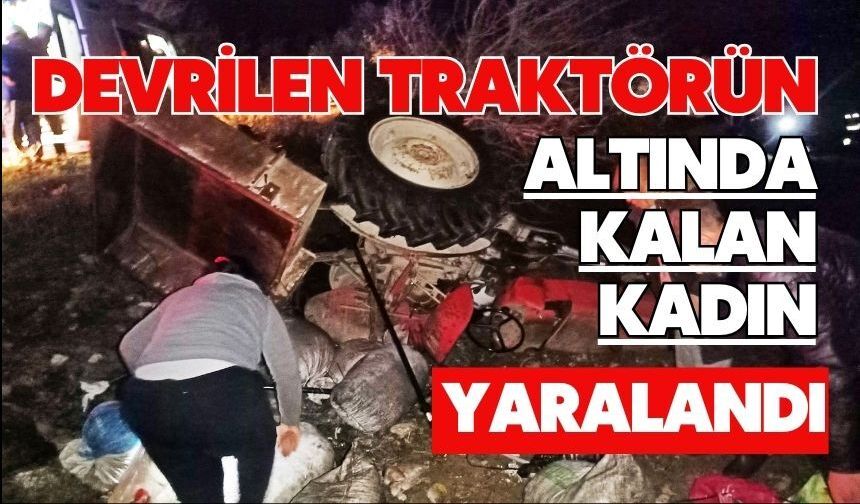 Devrilen traktörün altında kalan kadın yaralandı