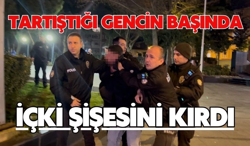 Tartıştığı gencin başında içki şişesini kırdı