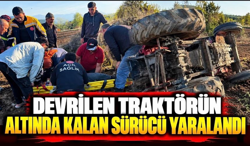 Devrilen traktörün altında kalan sürücü yaralandı